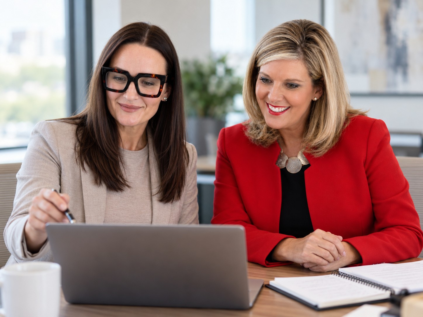 Leigh Fazzina reviewing communications work on a laptop with a client